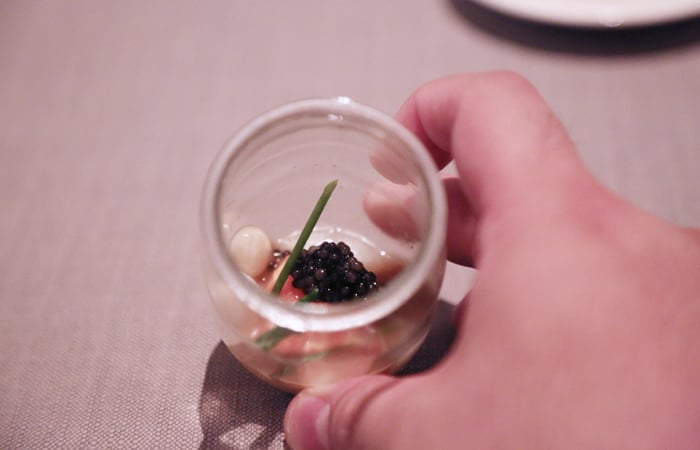 Inside we uncover a tasting of trout, Osetra caviar, lychee and chive. The star here is definitely the caviar with each tiny egg popping between your teeth and releasing the rich flavors within. The sweetness of lychee comes from a gel on the gold foil tab on top of the jar and lends a nice sweetness to the dish.