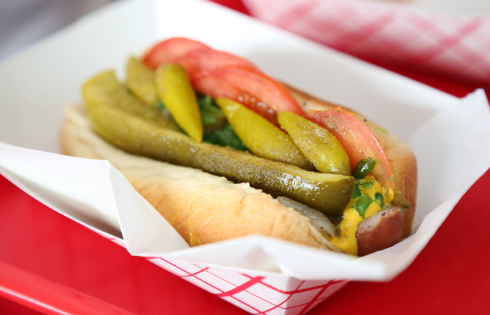 The iconic Chicago dog from Hot G Dog. An all beef hot dog topped with yellow mustard, chopped white onions, neon green sweet pickle relish, a dill pickle spear, tomato slices, pickled sport peppers and celery salt. Most importantly, no ketchup.