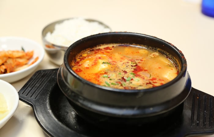 The still-boiling seafood soup ($13.95) is briny with shrimp, squid and butterfish. 