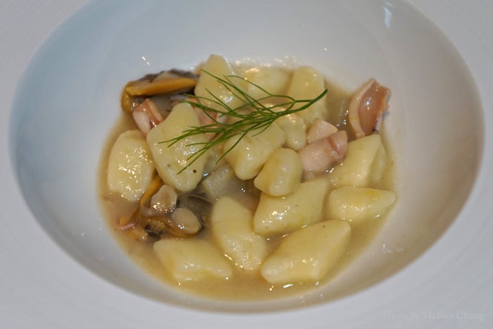 Lemon-scented potatoes gnocchi with fennel, squid and clams.