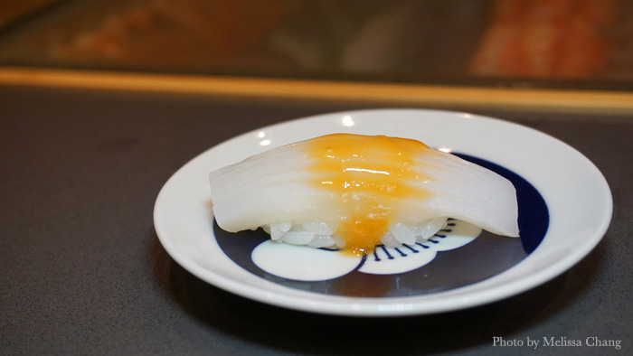 Tender ika nigiri topped with ibaragani (a kind of Hokkaido crab) eggs that aren't hatched or fertilized. 