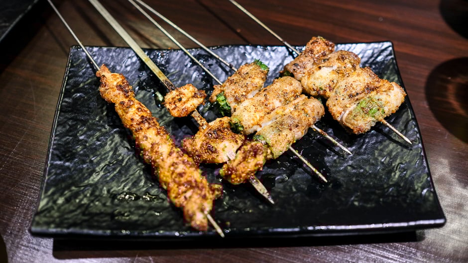 (L-R) Beef brisket and tendon, chicken cartilage, pork belly-wrapped shishito and pork belly-wrapped chives.