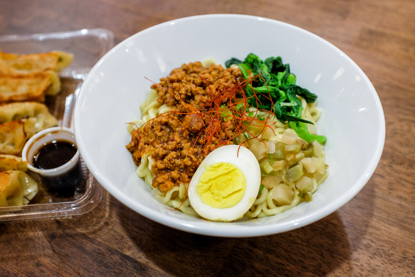Onoya's Tan Tan Mazesoba ($10) is a generous bowl of mazesoba noodles (think thicker than ramen and thinner than udon) topped with a mixture of dandan stir-fried ground pork, spinach and ham. Gingery, garlicky and little spicy with a hint of peanut—it's a hearty meal, especially when you add a six-piece yaki gyoza ($4.99) to your order.
