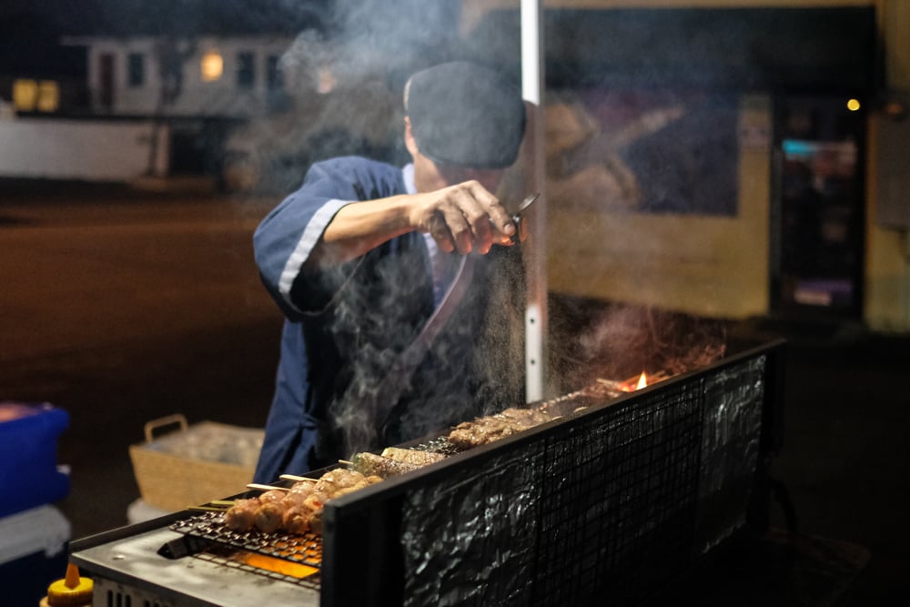 Chris Quisote, Hawaii's own salt bae, sets up Da Ala Cart tent around 9 pm in the Launderland parking lot on Beretania Street, to grill kushiyaki for a motley crew of patrons. Chris posts his menu on Instagram early in the day to announce his opening and offerings.