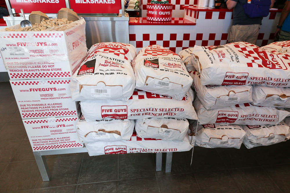 50 pound bags of potatoes that Five Guys sources from farms and cuts fresh for fries each day. 