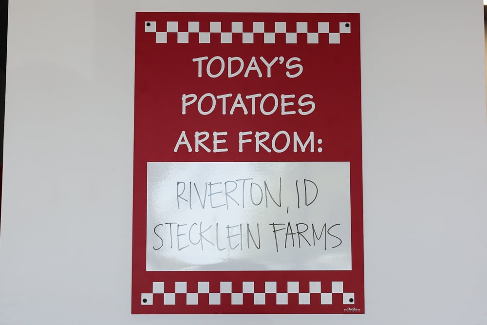 Each Five Guys location proudly displays the region and farm that grew the potatoes for the fries they are cooking up that day. 