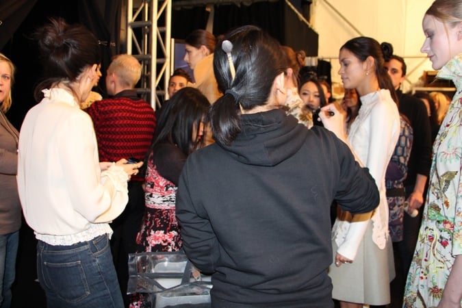 Vivienne Tam takes a last look at the models in the line-up before the show.