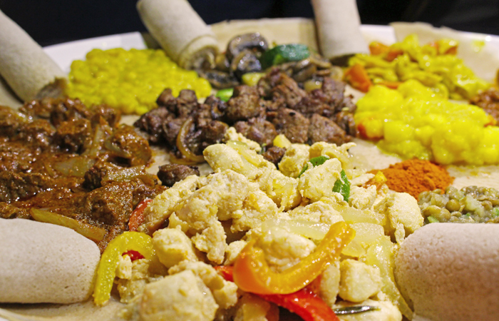 See those rolls on the edges of the plate? This is injera flatbread, which has a spongy texture and a bit of tang much like sourdough bread. No utensils here, use the injera to eat!