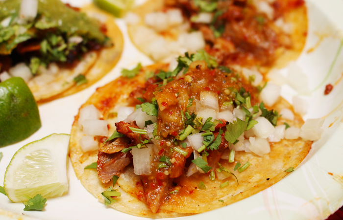 The succulent meat is cut right off the spit and onto your taco. Pick your sauce and get everything on it. 