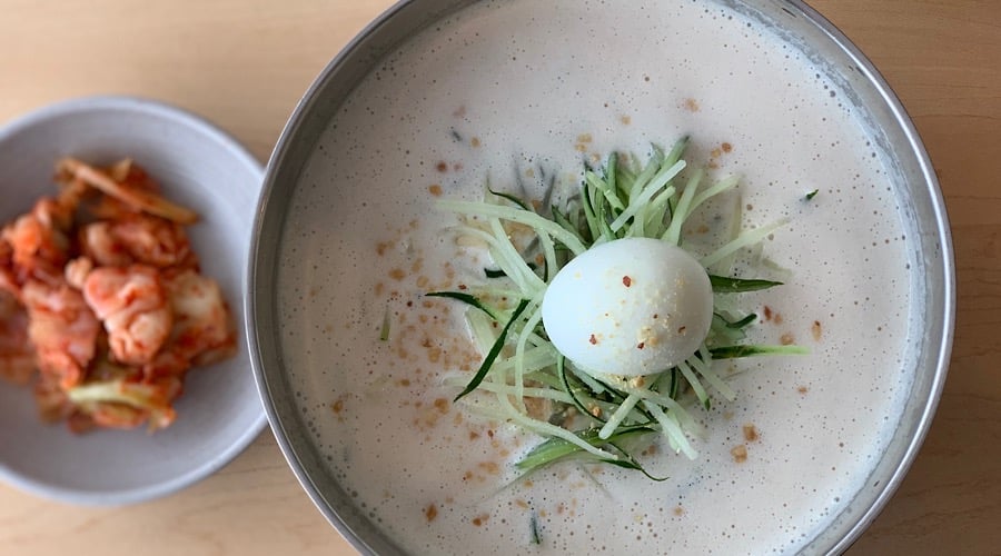 soy milk noodles with a side of kimchee