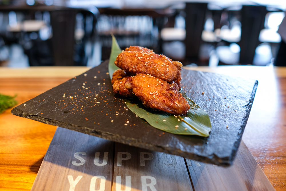 The umami shichimi chicken wings make for tasty bar fare. 