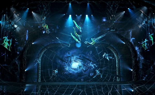 Zarkana trapeze artists flying through the tarantula's web. Picture credit : Jeremy Daniel, Richard Termine Costume credit : Alan Hranitelj ©2011 Cirque du Soleil