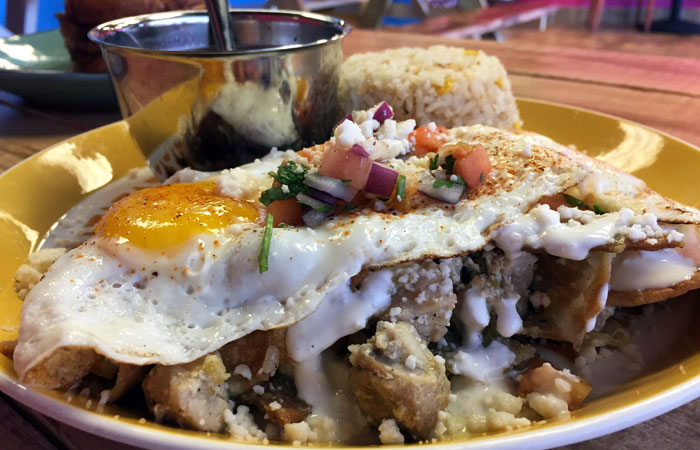 Chilaquiles ($12) feature lightly fried corn tortillas and your choice of red or green sauce. They’re topped with queso fresco, two eggs and a choice of meat — we order ours with chicken and green sauce.