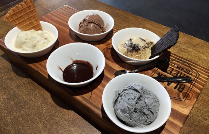 An ice cream flight gives you four different flavors, as well as your choice of homemade caramel or homemade hot fudge.