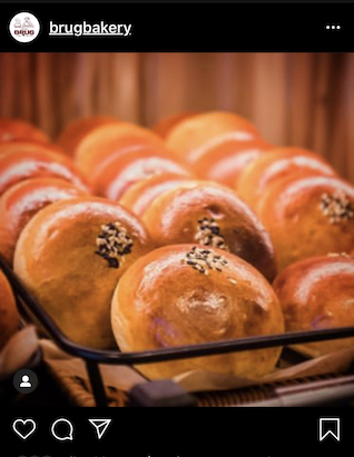 rows of shiny, golden, sesame-topped buns