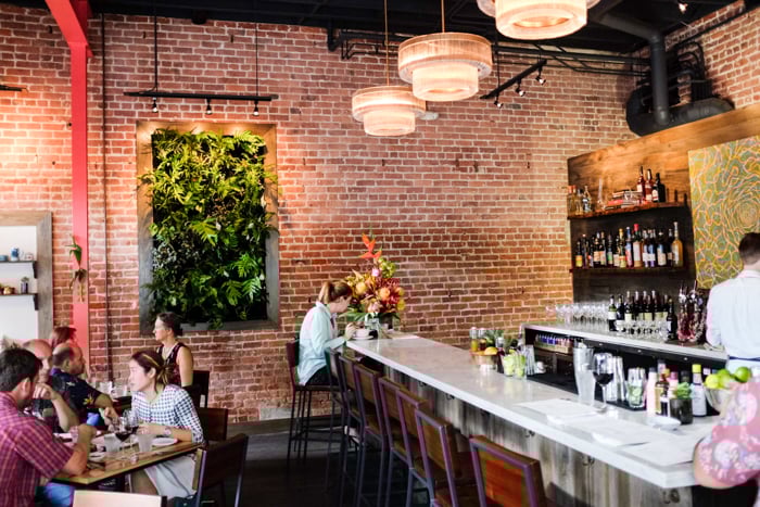 Hints of the restaurant's Brooklyn-meets-Hawaii roots can be found in the original exposed brick, rich hardwoods and custom lighting fixtures. 