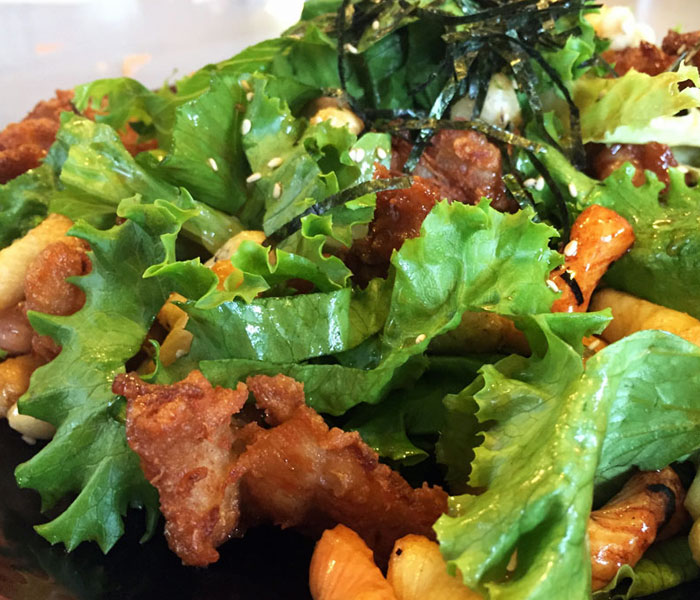 The plentiful kakimochi croutons are the best part of the mochiko chicken salad.