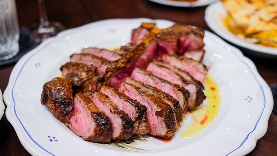 juices run from a generous plate of medium-rare steak slices