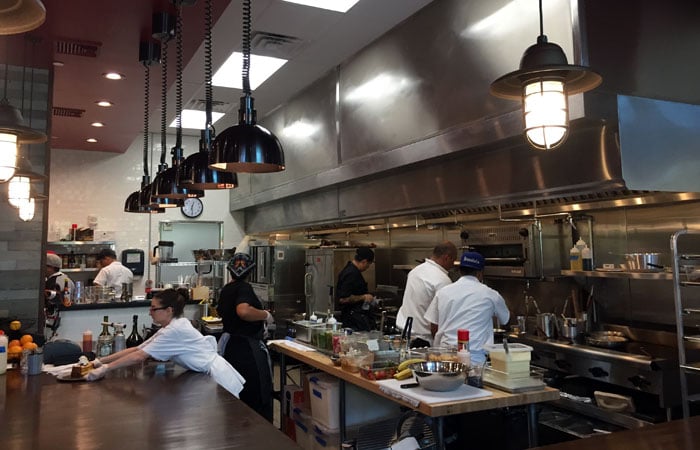 Meatery’s open kitchen is bigger, with a larger counter space. Chan says there are two kitchens in Meatery — the open kitchen and the back prep kitchen. In total, the kitchen is about half the size of the restaurant.