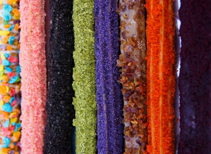 colorful lineup of khanom wan's eight churro flavors