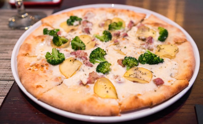 Frazzini Pizza - Potatoes, broccoli, pancetta, ricotta cheese sauce, topped with rosemary ($20)