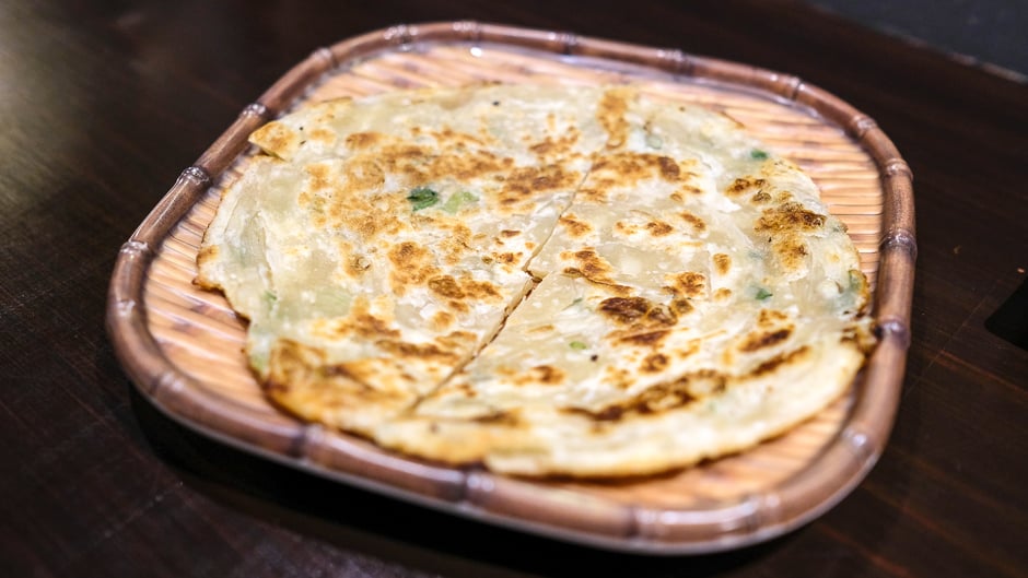 A scallion pancake sliced into four pieces