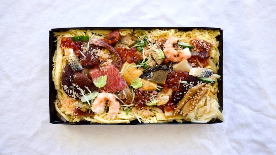 an array of seafood, shiitake and slivered omelet top an exquisite chirashi dish