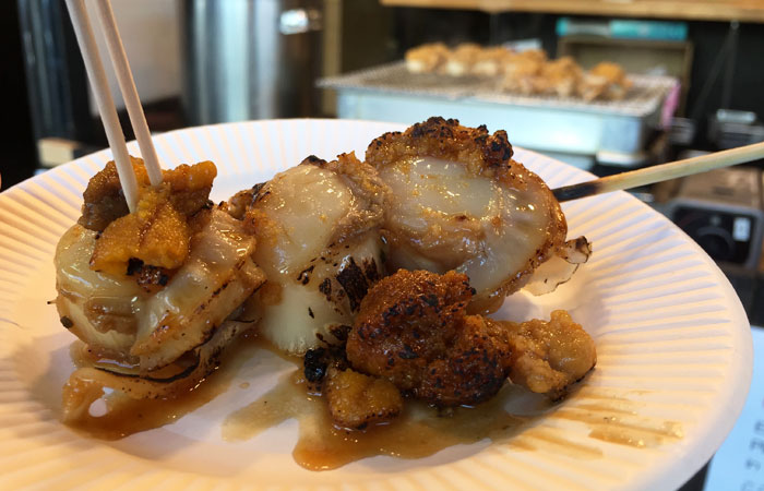 The vendor torched the scallops and uni before handing them to me on a plate. Talk about food and a show.
