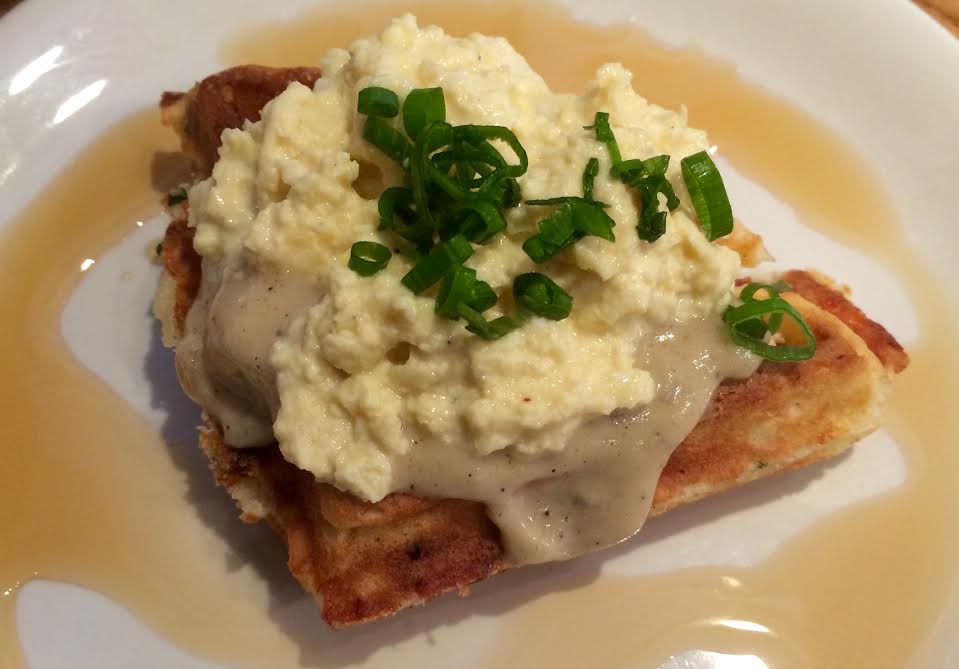 Koko Head Cafe - Cheddar Scallion Maple Waffle with house-made maple sriracha sausage gravy and creamy scrambled eggs, by celebrity chef Lee Anne Wong.  