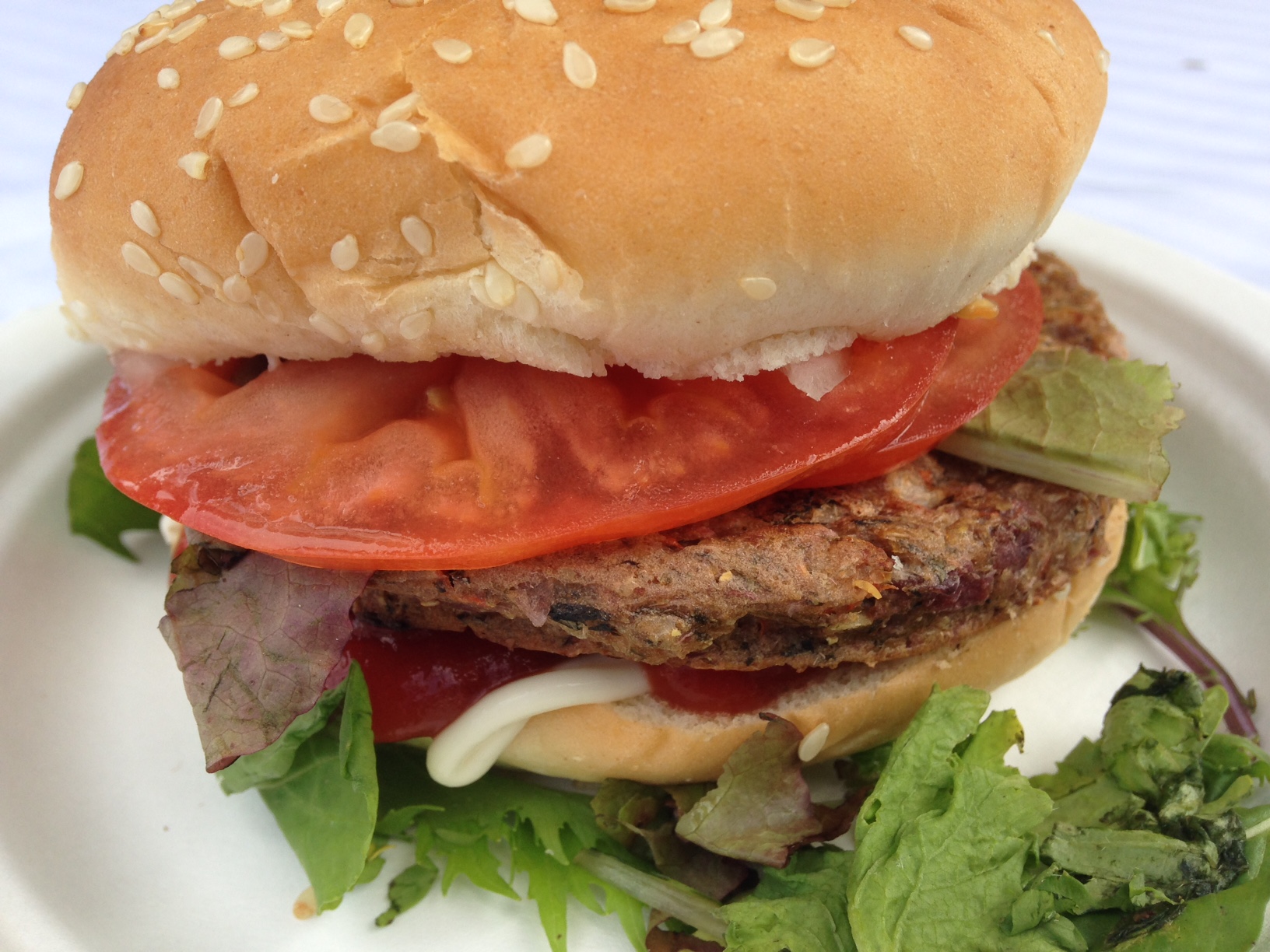 Taro burger patty with lettuce, tomato and onions.