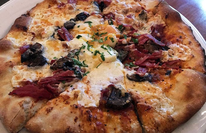 The Sopressata features crimini mushrooms and truffle oil, and it’s topped with an OK Farm sunny-side egg.