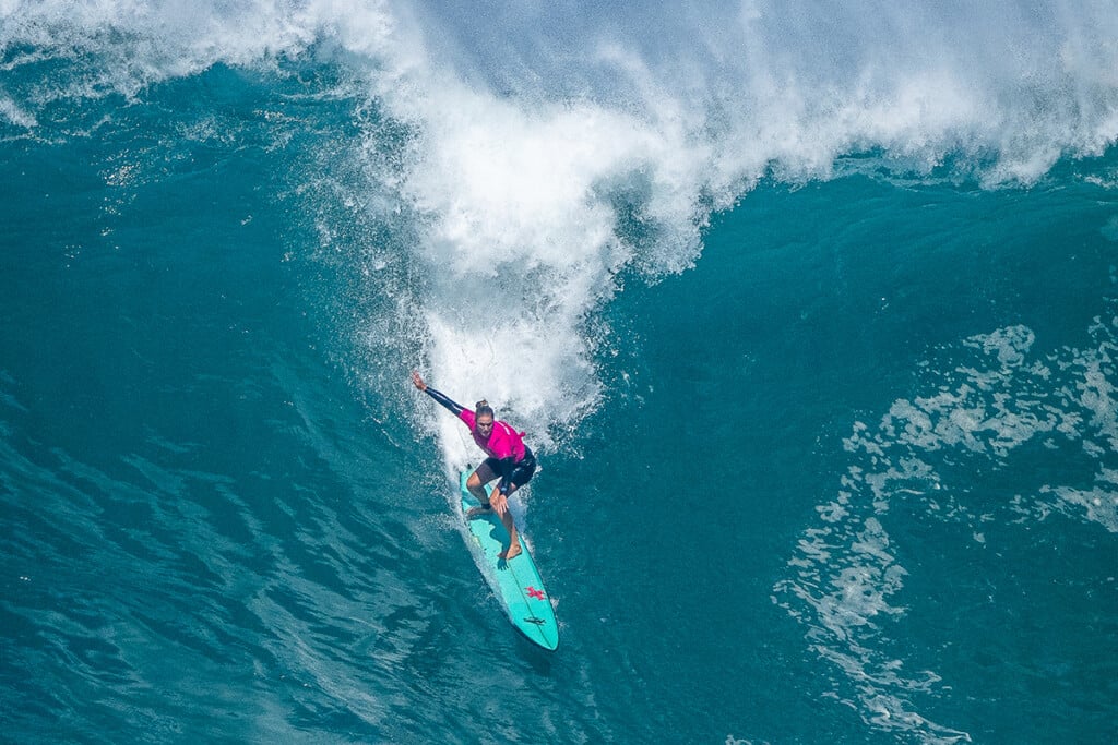 The Eddie Paige Alms female surfer riding wave