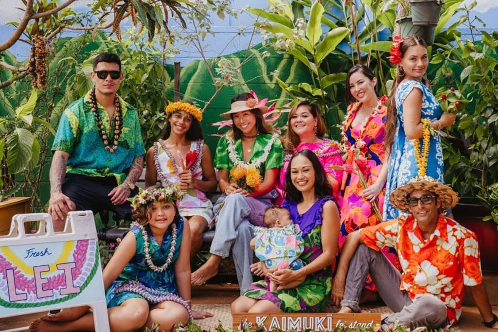 Image: Kaimuki Lei Stand - Credit: Pekuna Hong - Image of nine Hawaii women, men and children dressed in aloha shirts and mu‘umu‘u