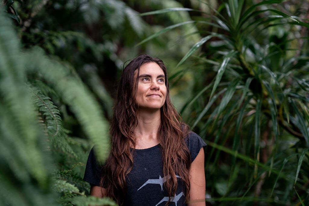 Emma Yuen, left, pauses under towering native trees of koa and ‘ōhi‘a lehua in the Pu‘u Ōhi‘a forest.