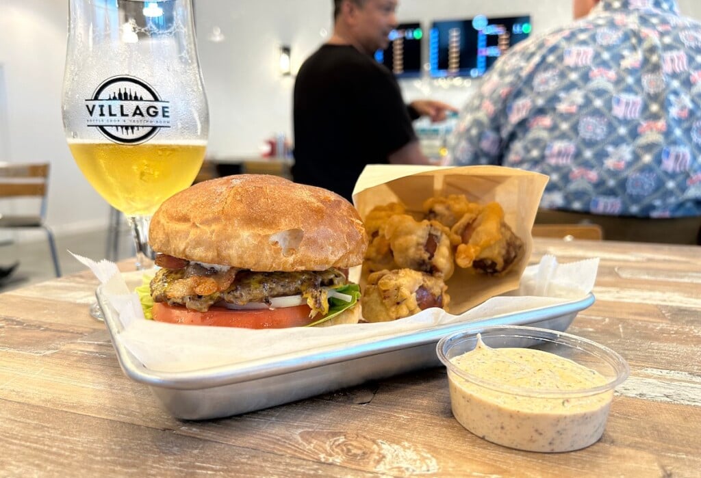 side view of burger, fries and glass of beer