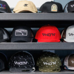 rows of baseball caps on shelf