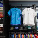 Pop-over men's shirts hanging on rack