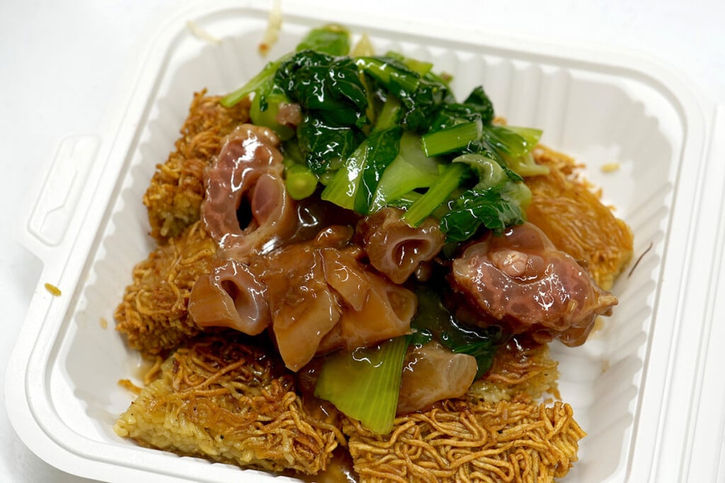 pieces of beef tendon atop Cake Noodles