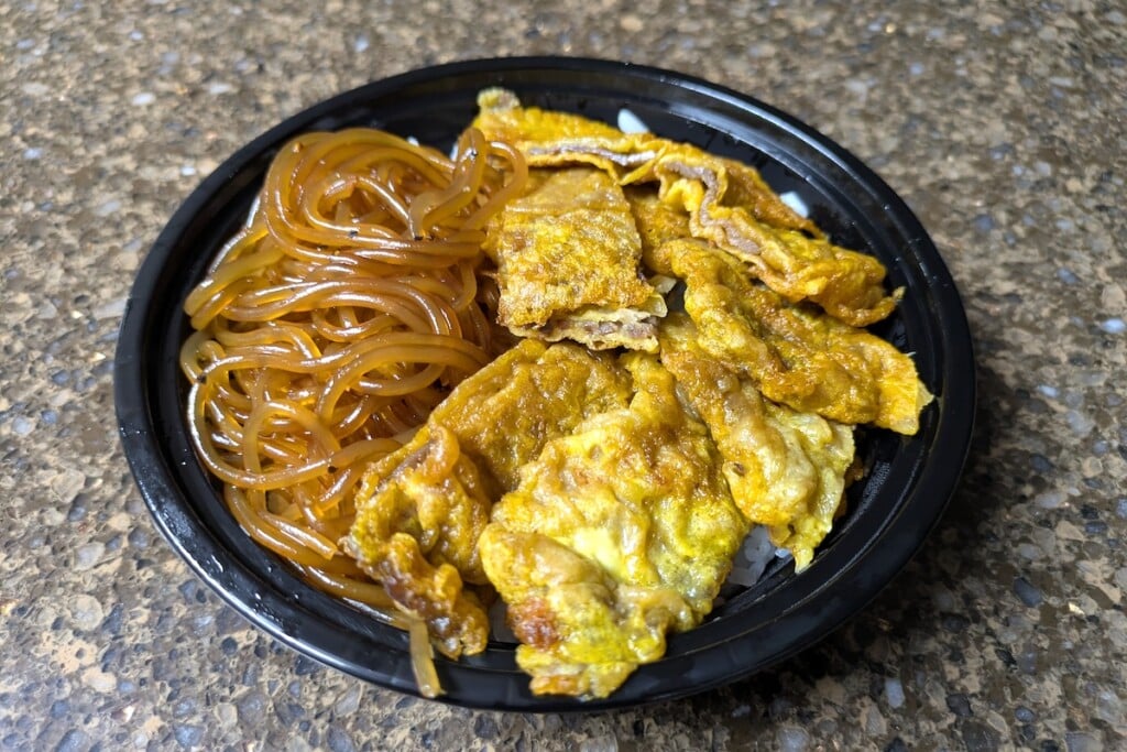 takeout bowl of Meat Jun and noodles