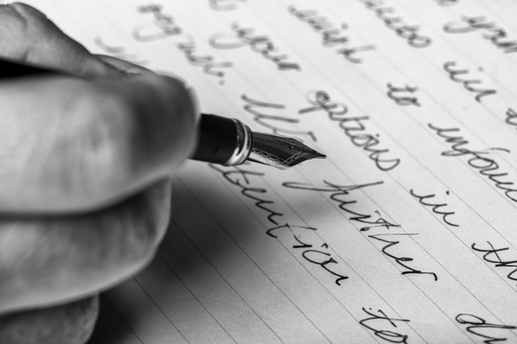 Hand Writes Words With A Fountain Pen On Paper