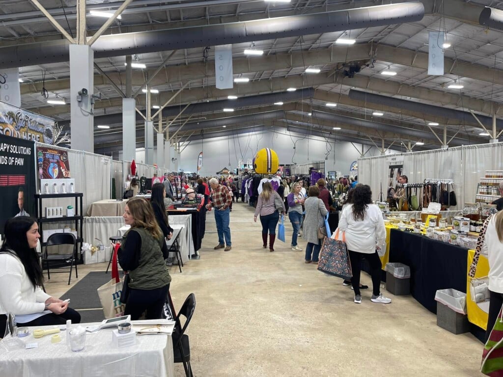 Photo of Lamar-Dixon interior with shopping vendors and shoppers at the Holiday Market