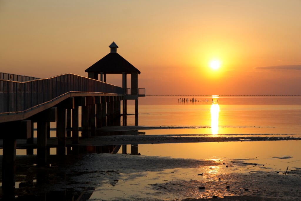 Sunset along Lake Pontchartrain with a gazebo in the foreground.