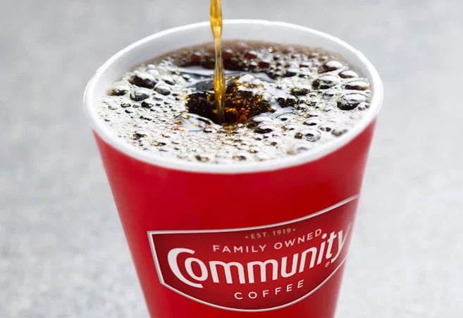 Community Coffee cup with coffee pouring into it