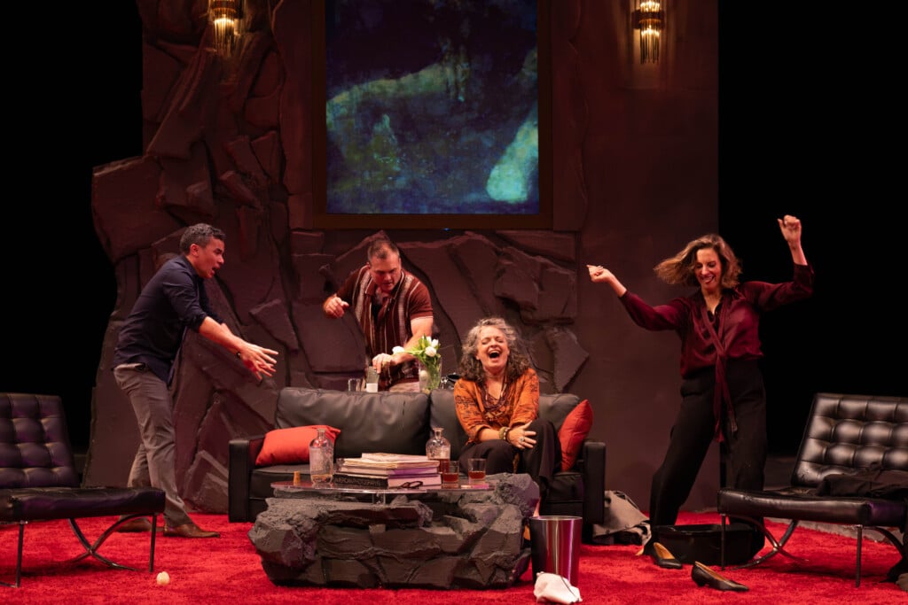 "God of Carnage" at Le Petit Theatre. Four actors on stage. Three standing with chaotic movements and one sitting and screaming.