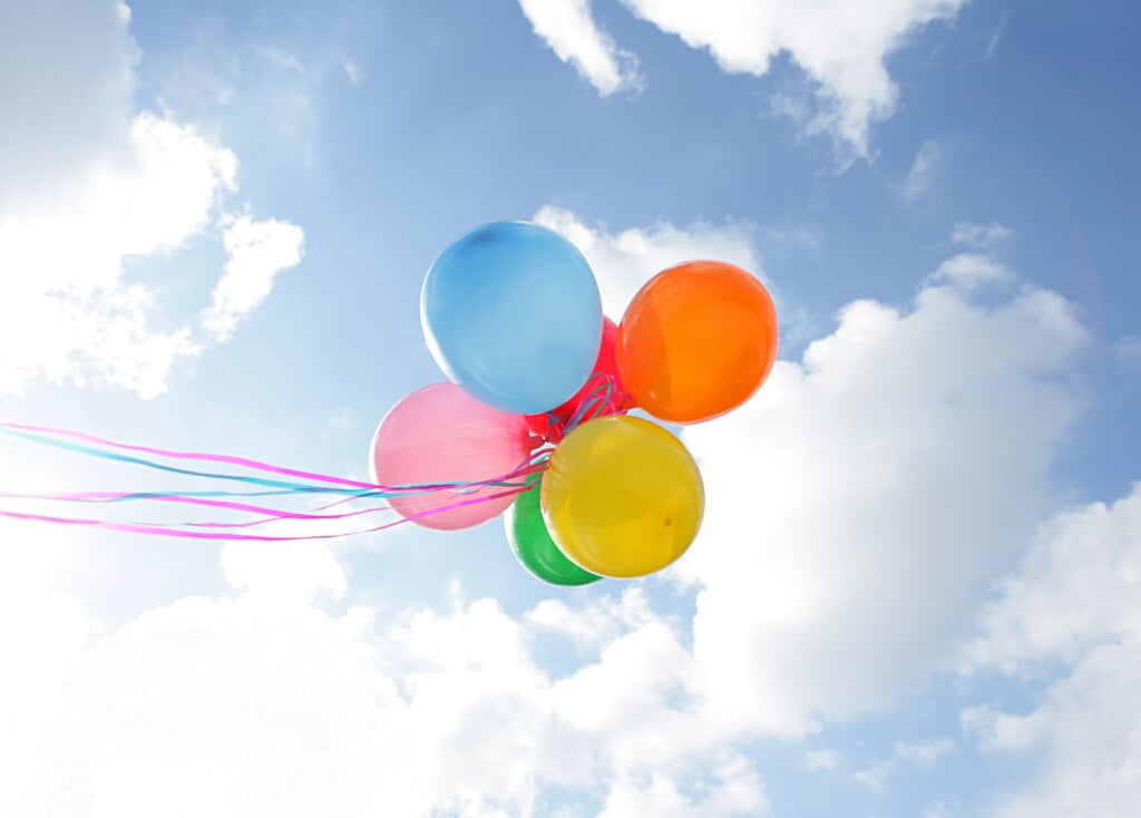Balloons released in a bunch on a cloud day