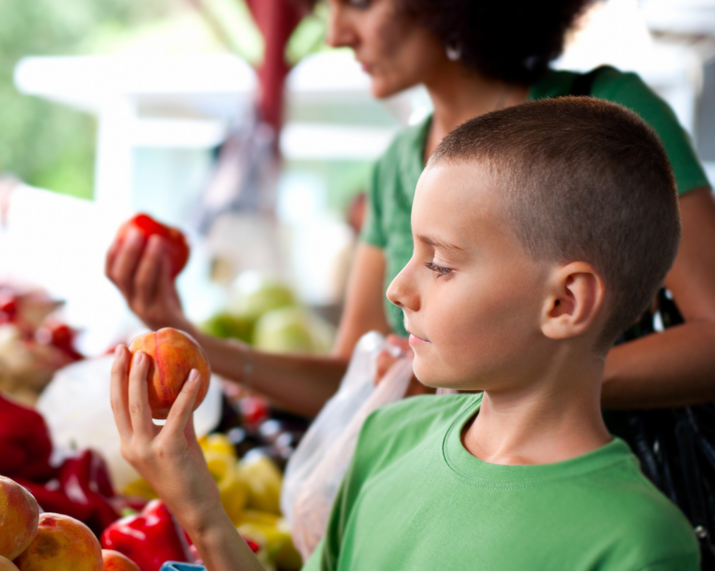 Kid Grabbing Peach From Market