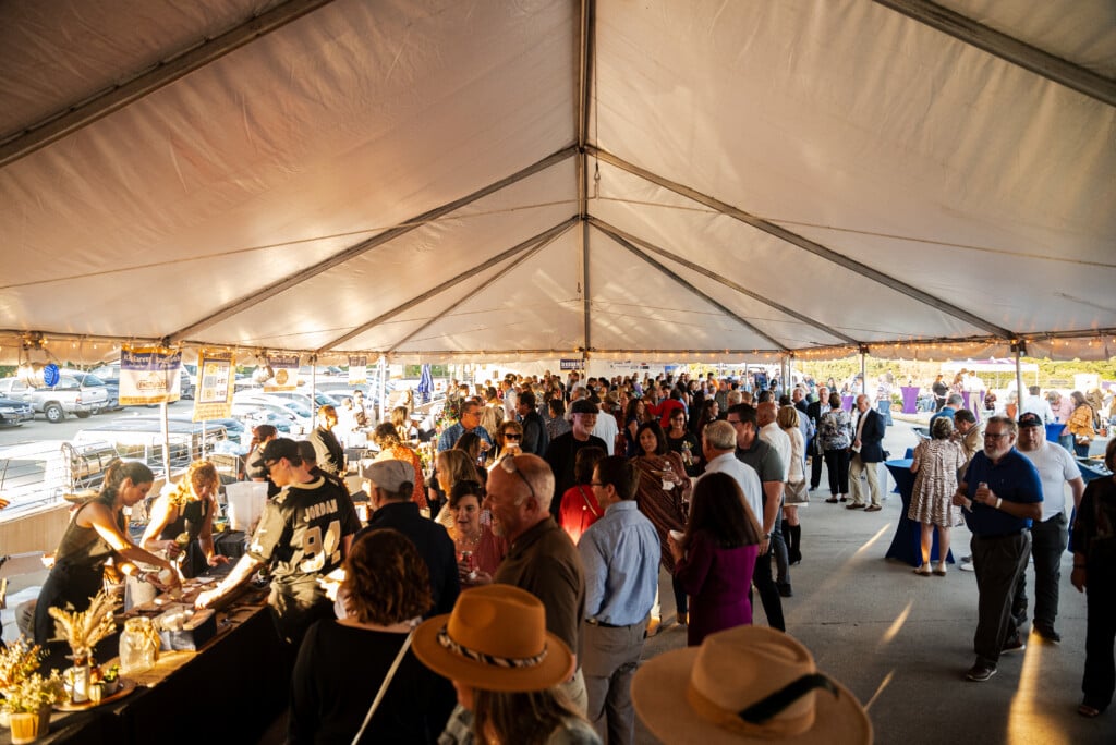 Heroes Who Cook crowd under tent in Covington, La.