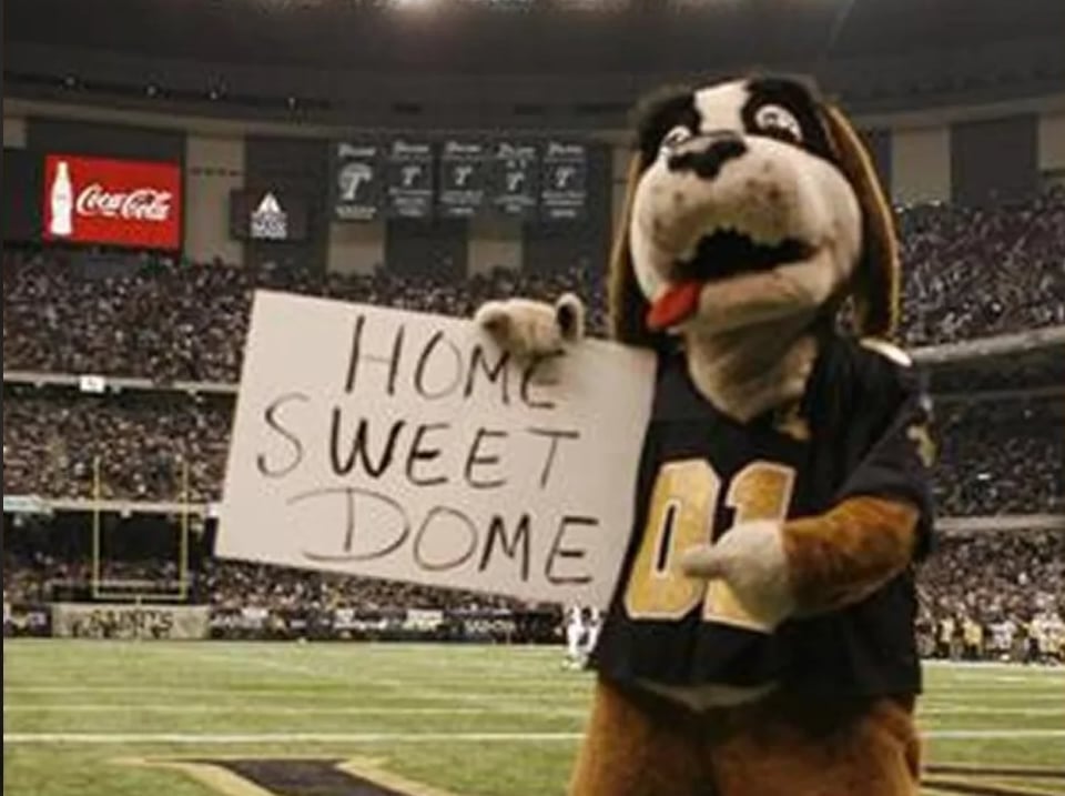 Saints mascot Gumbo the Dog holds sign reading, "Home Sweet Dome" for the Sept. 25, 2006 game when the Saints returned to the Superdome after Katrina