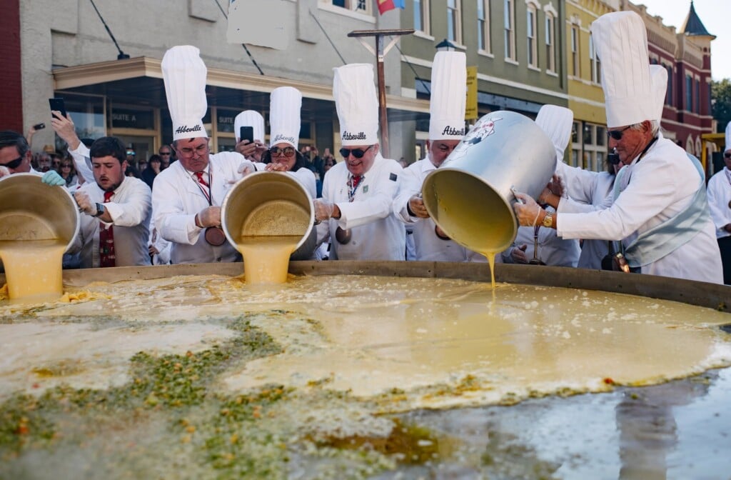 Great Omelette Festival in Abbeville photo for November Festivals in Louisiana Festival Guide. Photo of men in chef hats pouring eggs on large surface