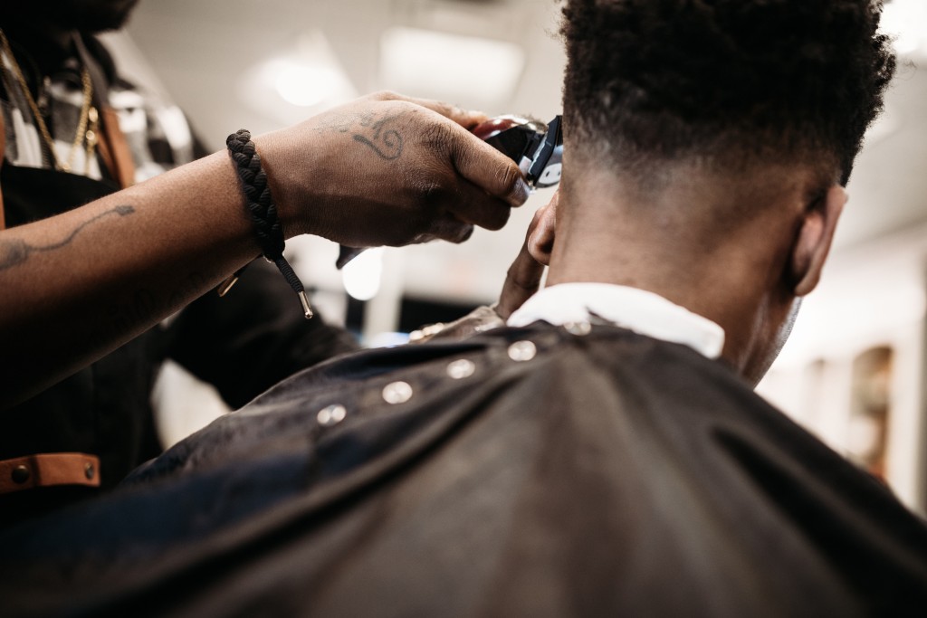 Barber Giving A Haircut In His Shop